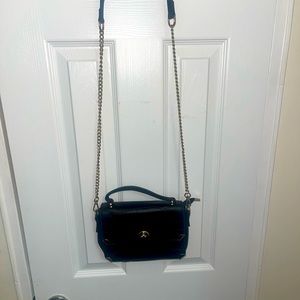 Small black bag with golden metal strap